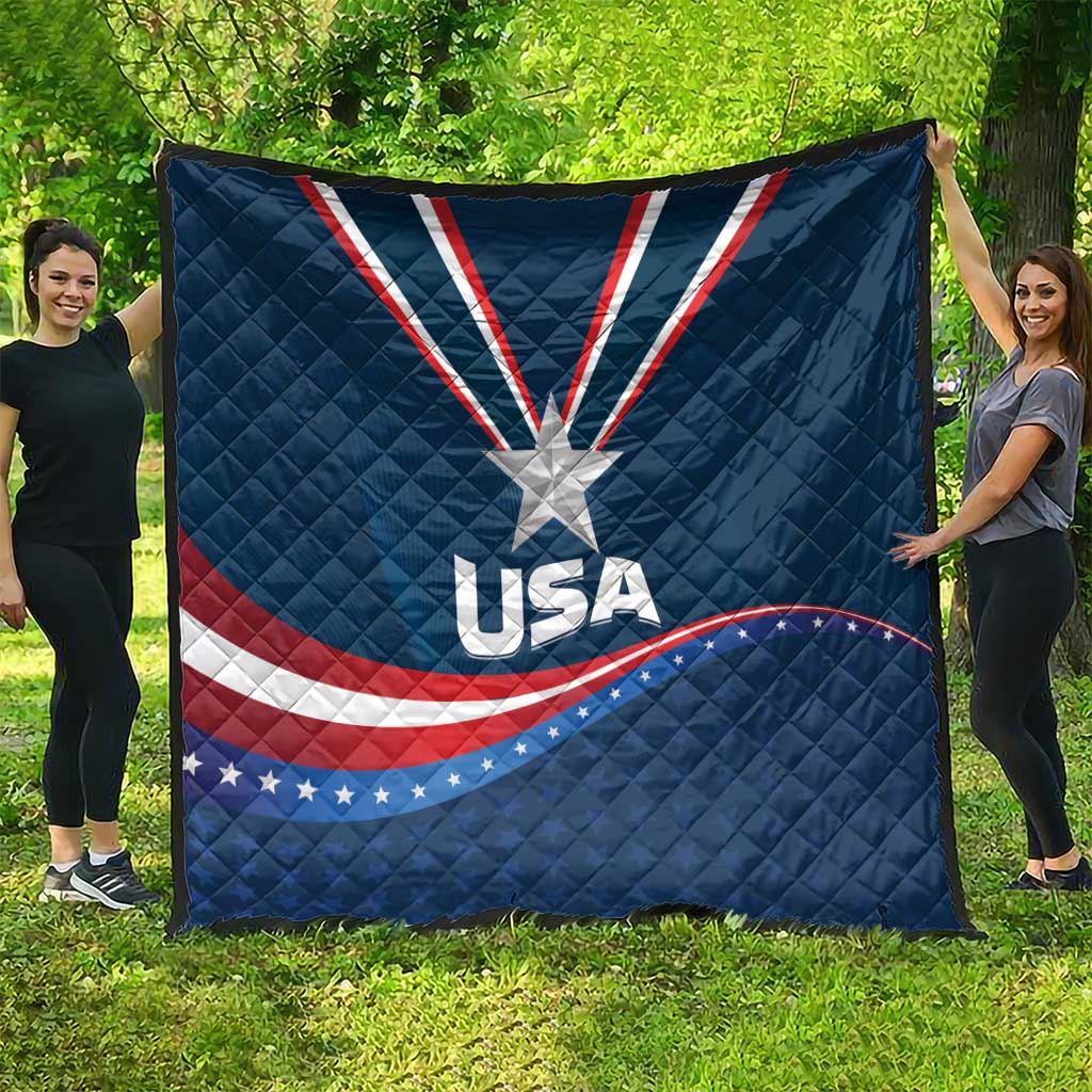 USA star medal quilt spread on lawn, blue with white star and red/white wave ribbon stripes