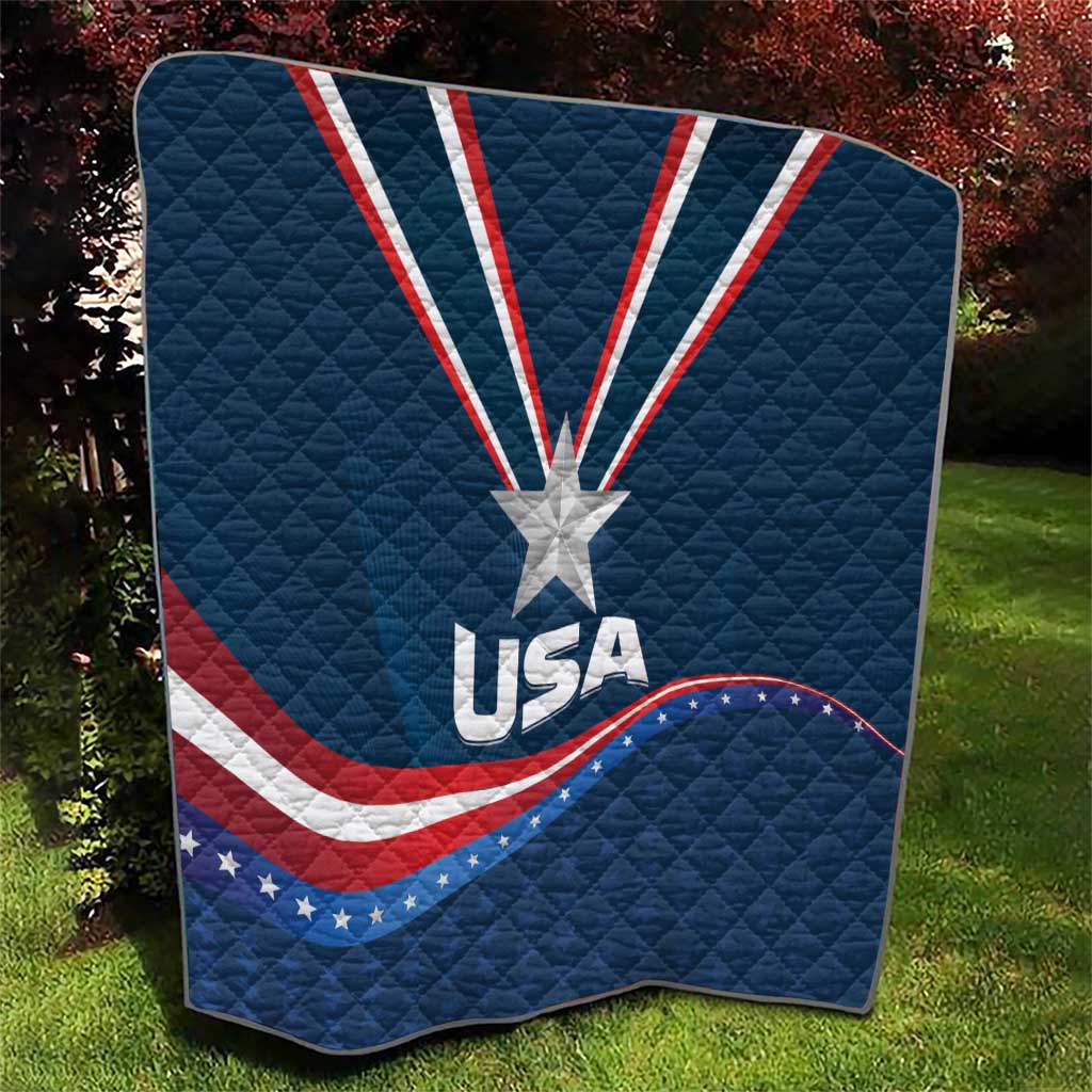 USA star medal quilt on grass, blue quilt with white star and red/white curved wave stripes
