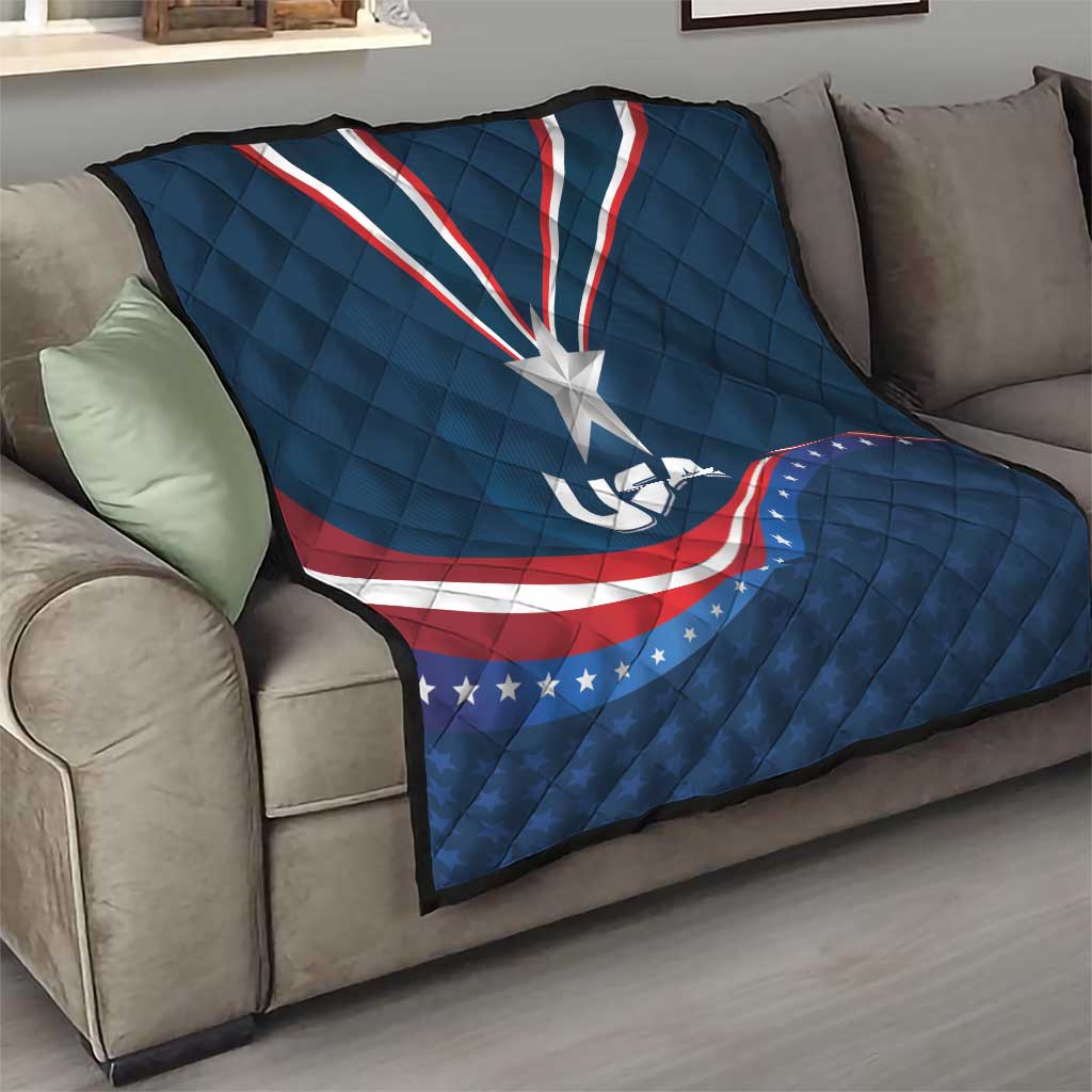 USA star medal quilt on sofa, blue cover with white star and red/white wave stripe design