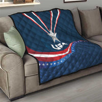USA star medal quilt on sofa, blue cover with white star and red/white wave stripe design