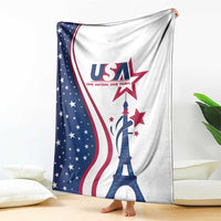 USA flag and Eiffel Tower print blanket draped over bed, white top with blue star field