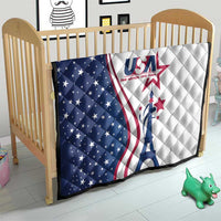 USA-themed quilt on a crib, blue star section left, white section right, Eiffel Tower graphic