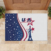 Rubber doormat with large USA logo and Eiffel Tower silhouette, white and navy graphic