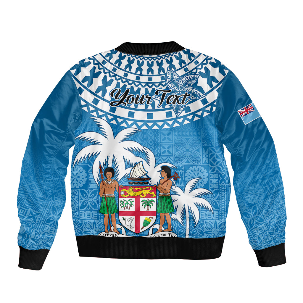 Blue bomber jacket with back graphic 'Your Text', tapa pattern, palm trees and crest