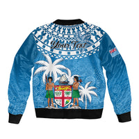 Blue bomber jacket with back graphic 'Your Text', tapa pattern, palm trees and crest
