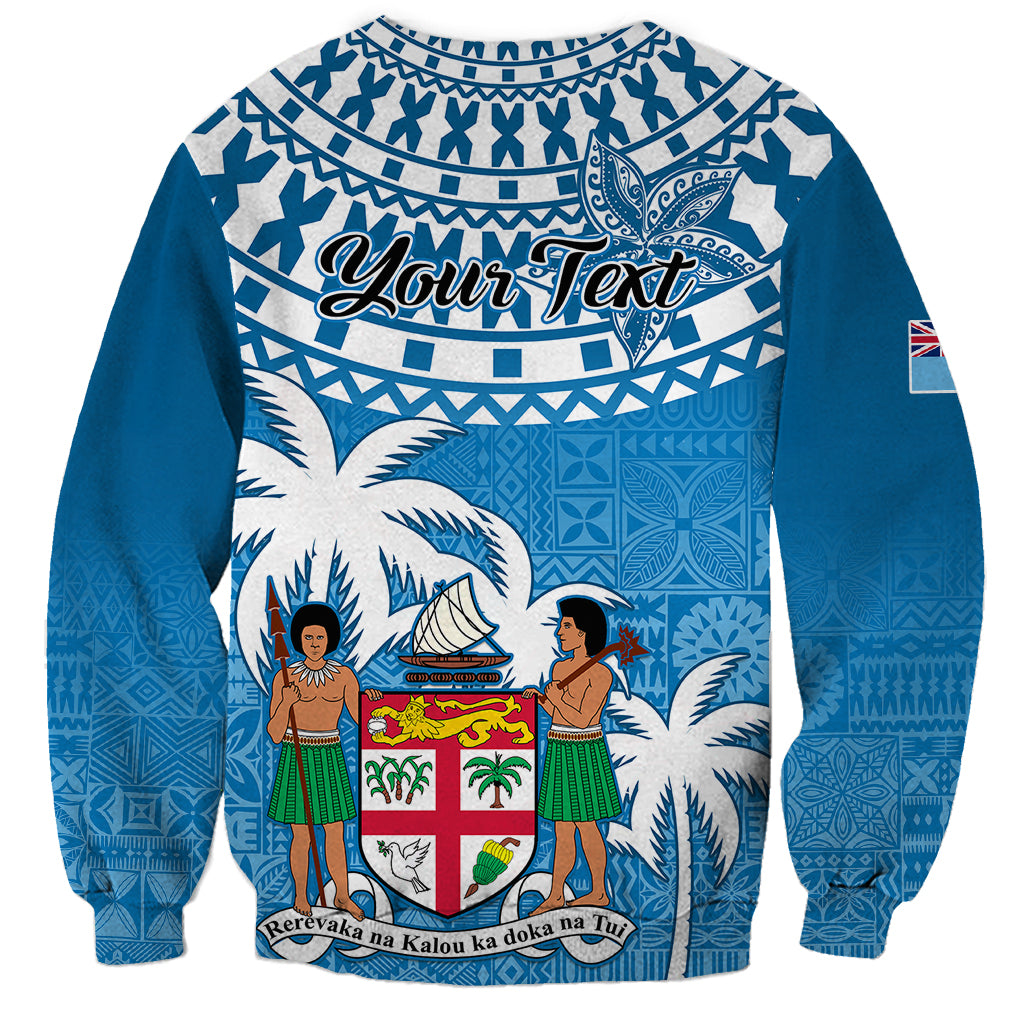 Blue unisex sweatshirt with tapa pattern, Your Text banner, and Fiji emblem