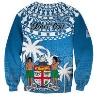 Blue unisex sweatshirt with tapa pattern, Your Text banner, and Fiji emblem