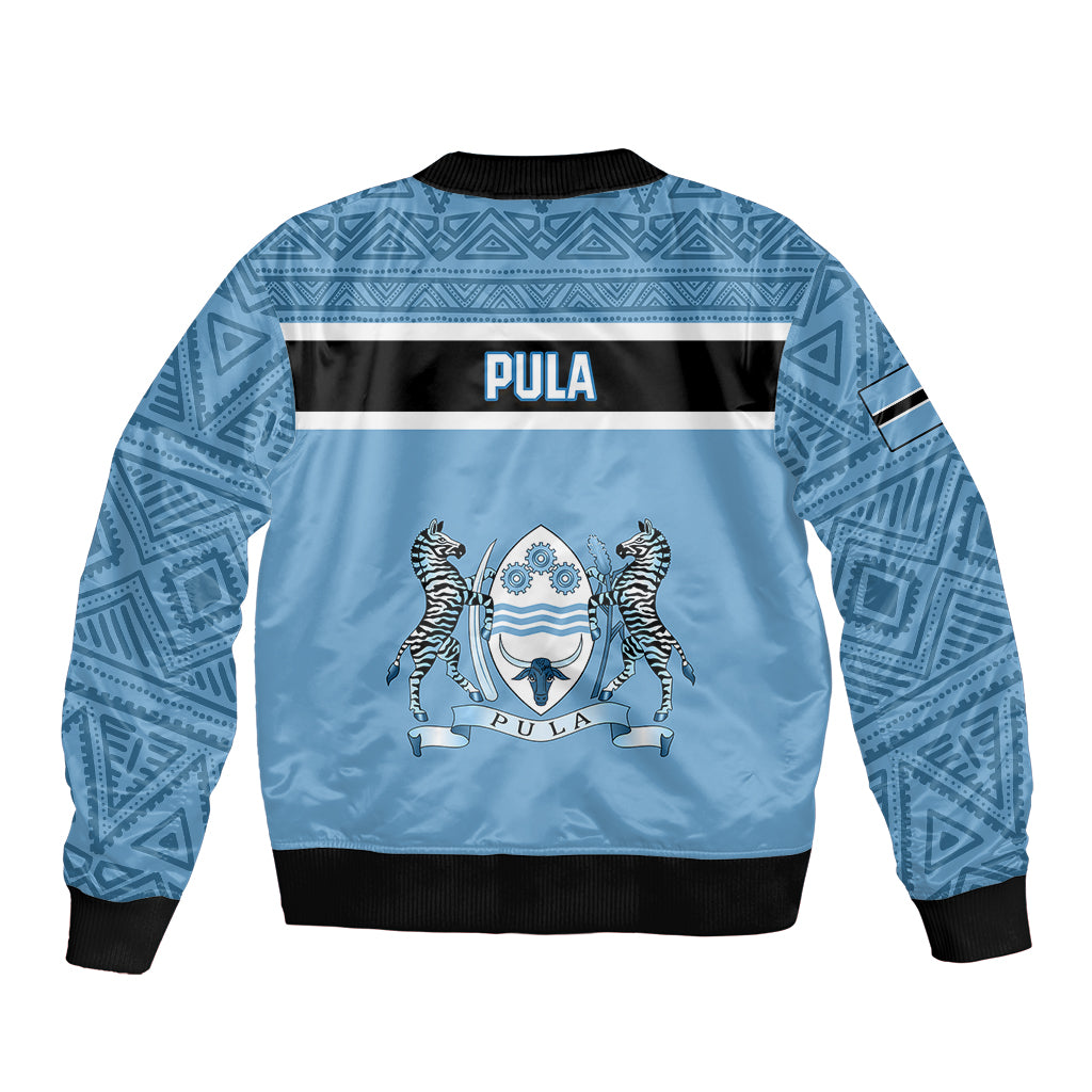 Blue unisex bomber jacket back view with African pattern and centered crest graphic.