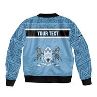 Blue bomber jacket back with 'YOUR TEXT' band and central emblem graphic.