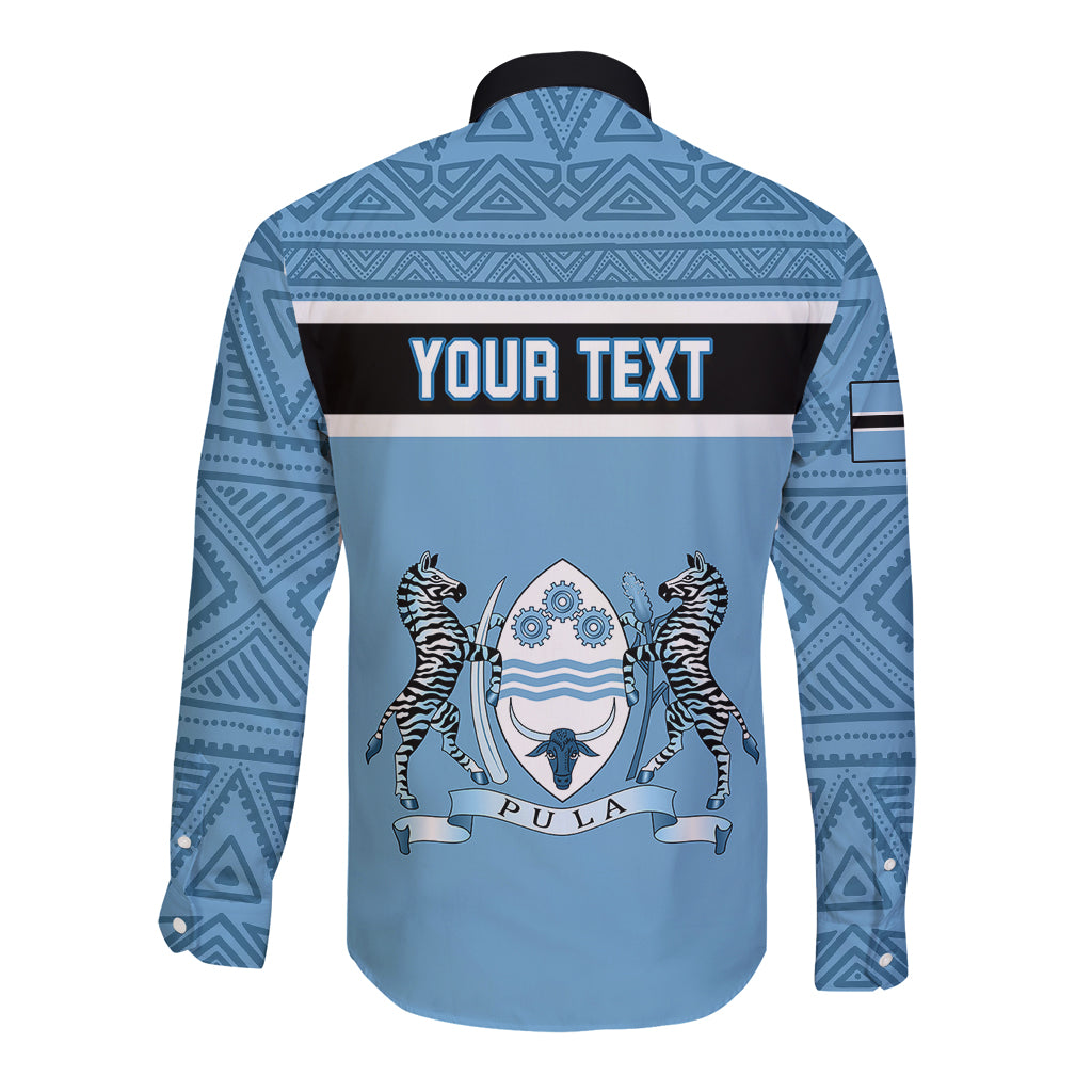 Blue long-sleeve button shirt with dark collar and Your Text Pula graphic panel.