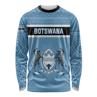 Blue long-sleeve crewneck shirt with tribal pattern and Botswana text over zebra emblem