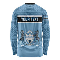Blue long-sleeve crewneck shirt with tribal pattern and YOUNH TEXT banner over zebra emblem
