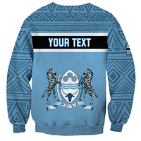Blue crewneck sweatshirt with tribal pattern and custom text banner over emblem print