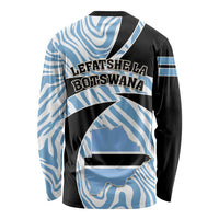 Long-sleeve shirt back view in black and blue with zebra swirl print and text