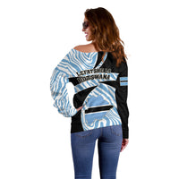 Women’s off-shoulder sweater side/back, blue zebra stripes over black with Botswana badge graphic