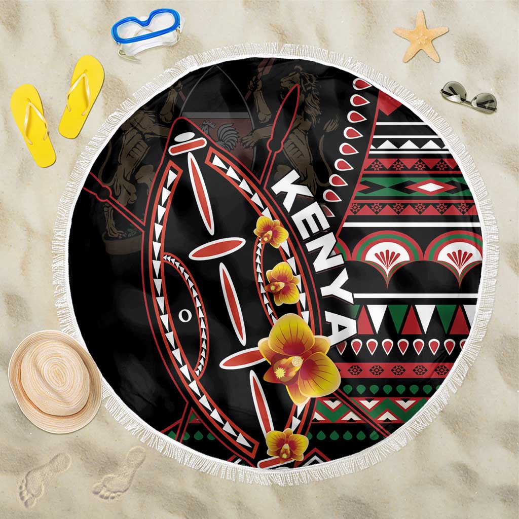 Black round beach blanket with colorful fish-and-flowers shield graphic and white fringe