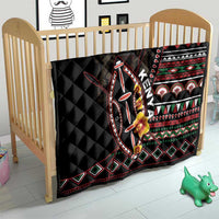 Black quilt with diamond and stripe tribal pattern, floral accents and shield design.