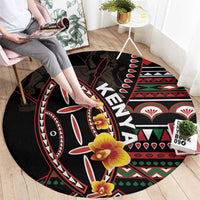 Black round carpet featuring tribal shield artwork with yellow-orange flowers