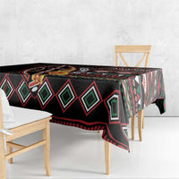 Black tablecloth with red, green, and white diamond stripe pattern and floral details