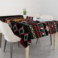 Black tablecloth draped over dining table with geometric diamonds and red border trim