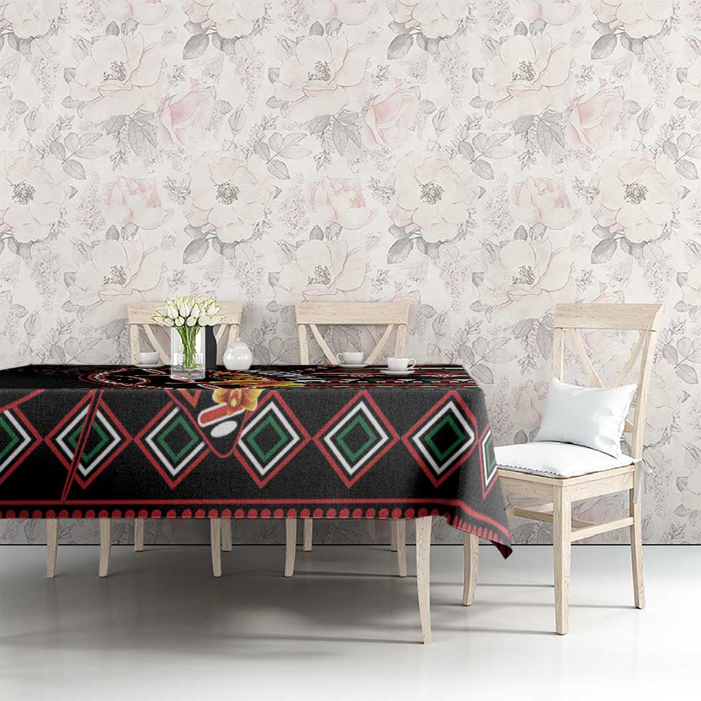 Black patterned tablecloth with diamond shapes, red accents, and floral graphics on top