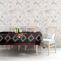 Black patterned tablecloth with diamond shapes, red accents, and floral graphics on top