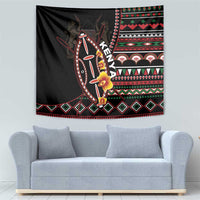 Black tapestry wall hanging with colorful shield, flowers, and geometric border
