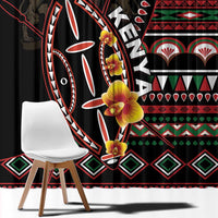 Close-up of black window curtain fabric with red, white, green tribal shield design
