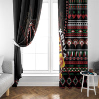 Black window curtains with red, green, and white tribal patterns, one tied to the side
