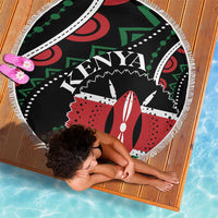 Round beach blanket with fringe on black base; colorful Kenya graphic center