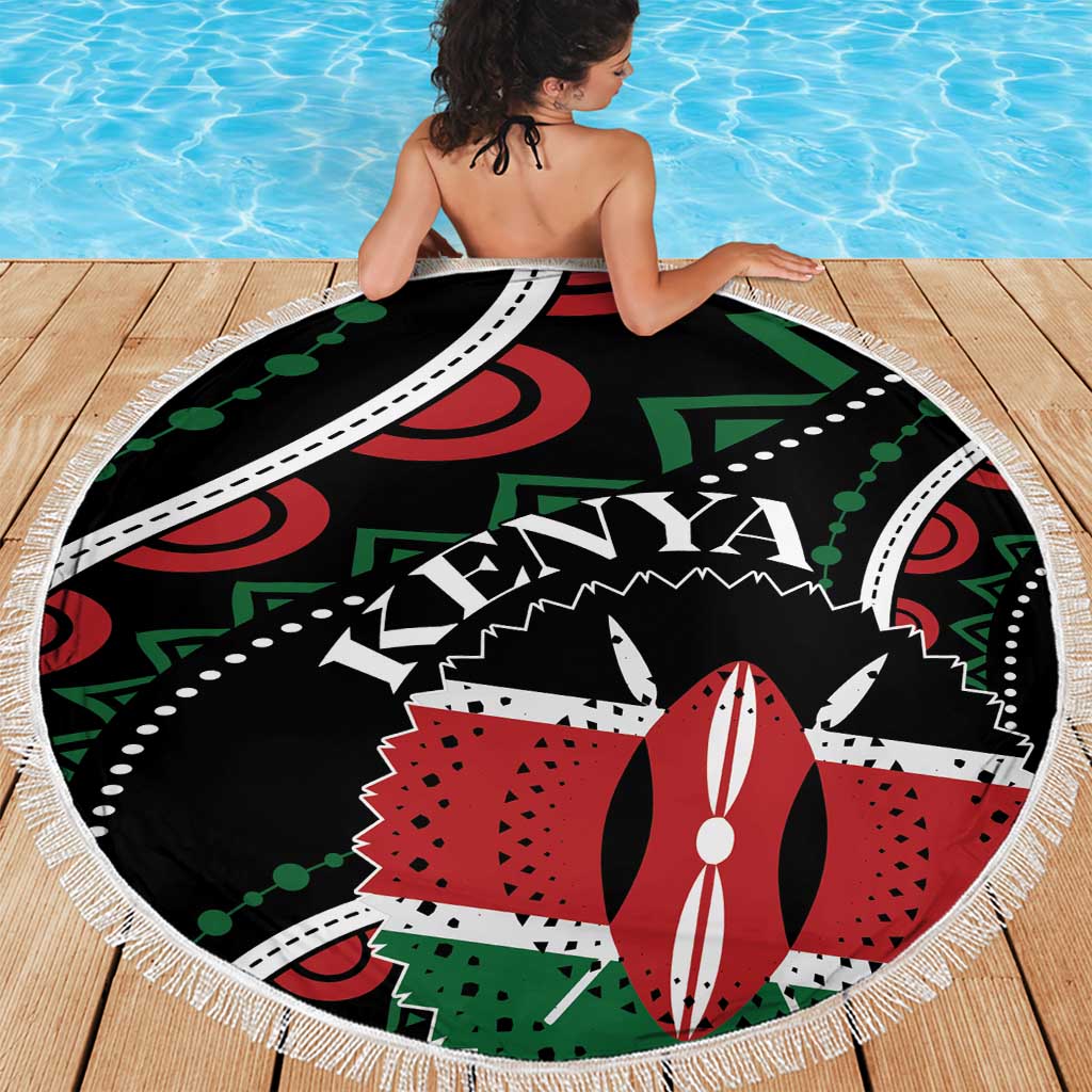 Round beach blanket on deck; black Kenya graphic with white fringe border