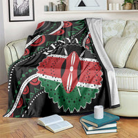 Black Kenya blanket draped over sofa, bold red and green graphic with “KENYA” text