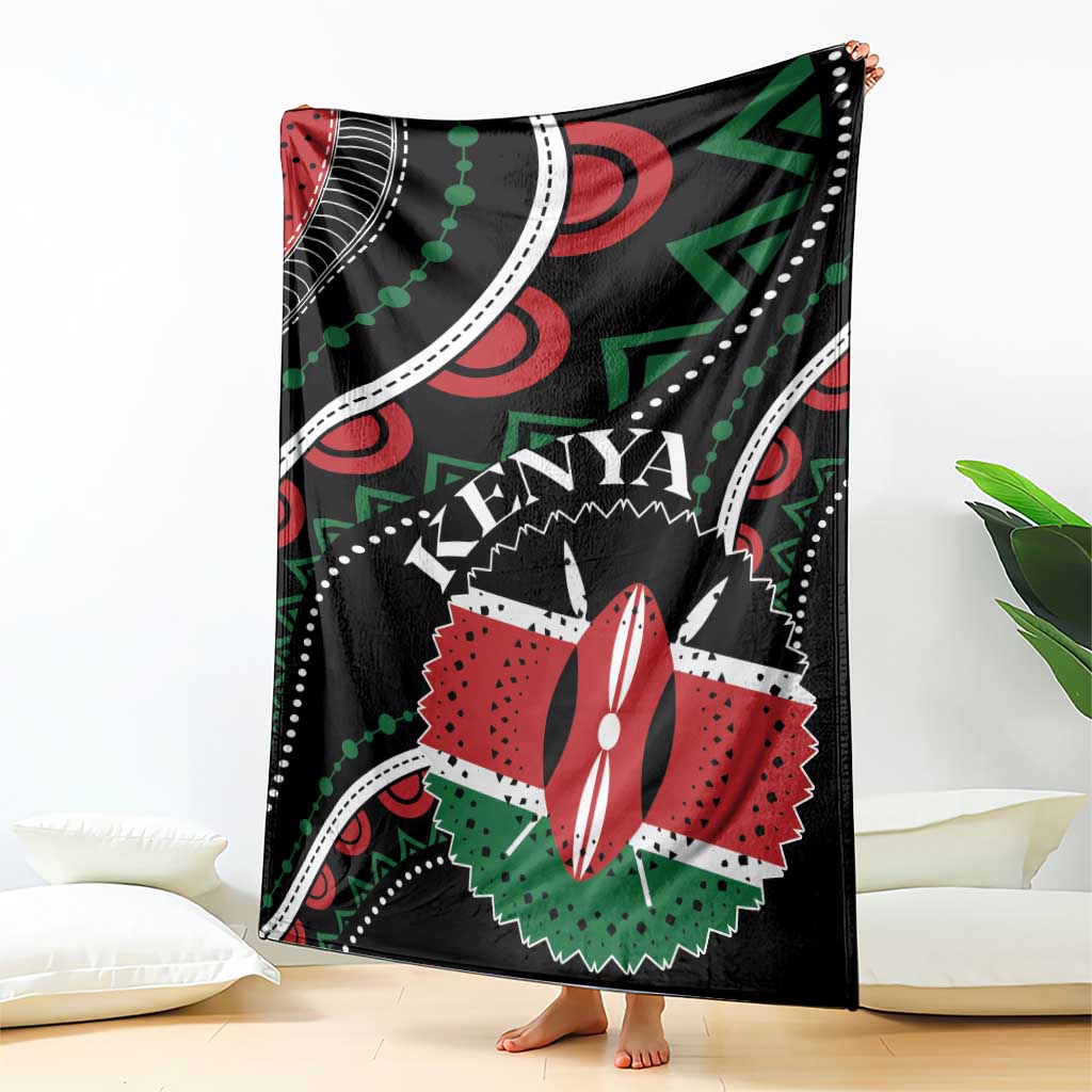 Black Kenya blanket hanging on floor with large “KENYA” graphic and red-white flower motif