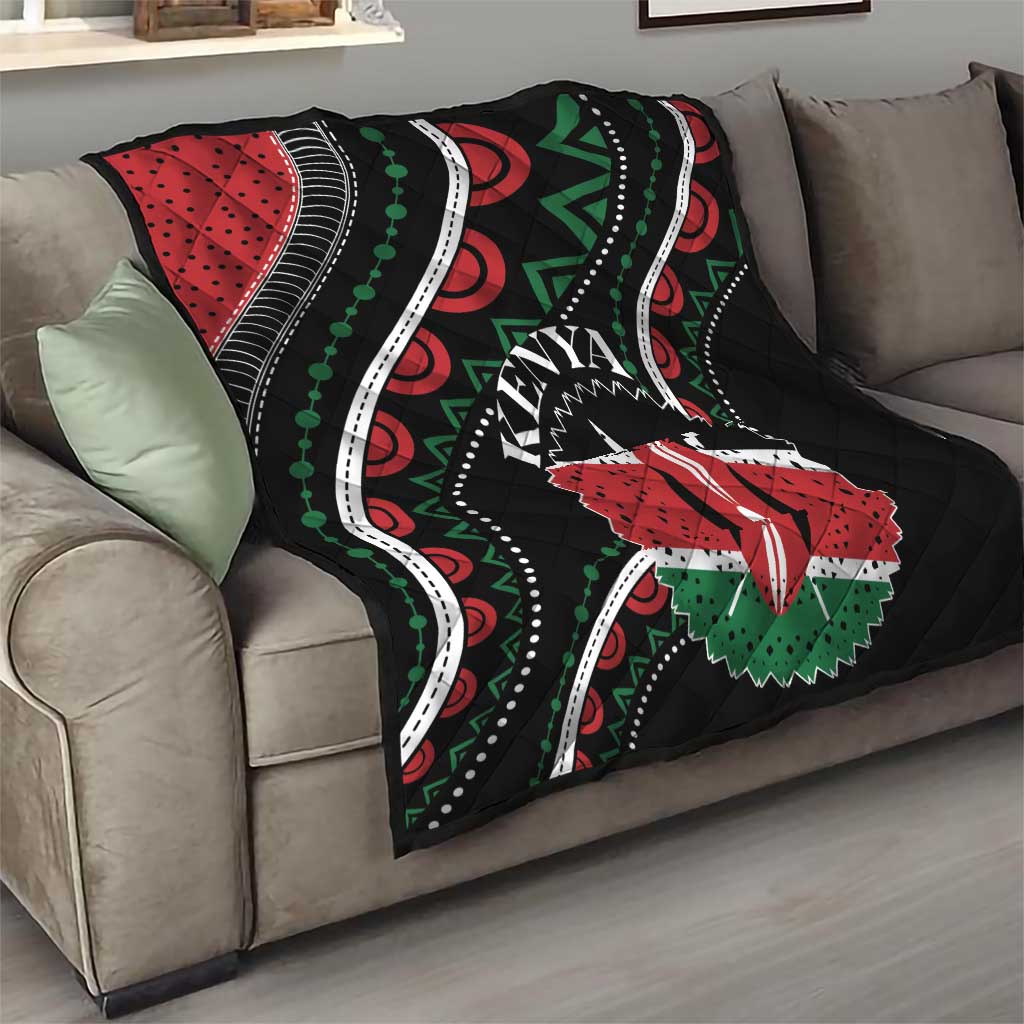Black quilt on sofa with red-and-green star flower, Kenya text, and white curved stitch lines
