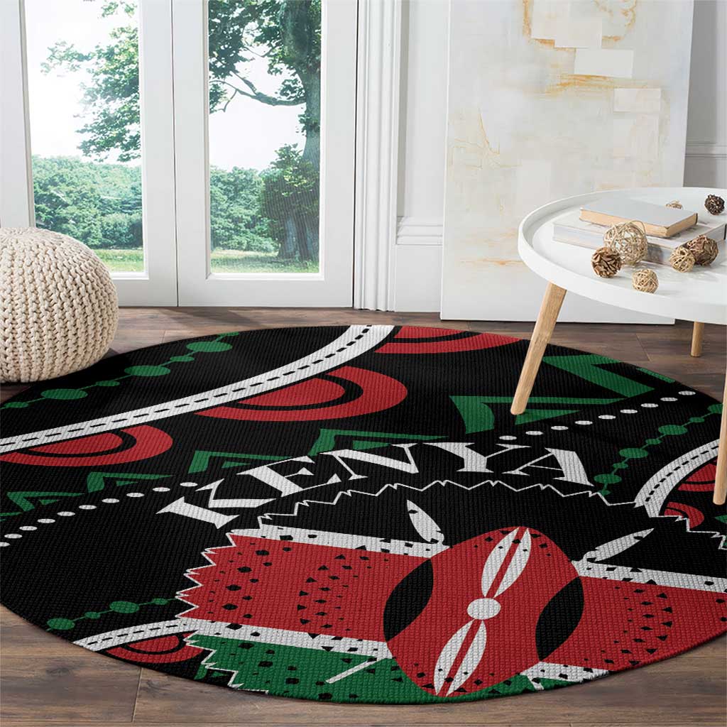 Round black rug with red, green, and white graphic pattern, laid on hardwood