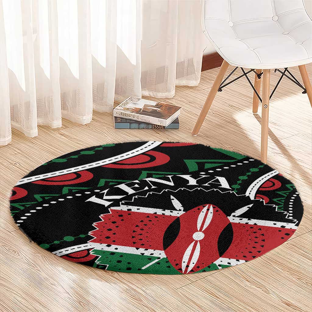 Round black area rug featuring red and green geometric design with white accents
