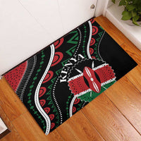 Black rubber doormat with Kenya lettering, red and green geometric African design.