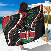 Black sarong wrap laid out with detailed red, green, white circular and stripe pattern