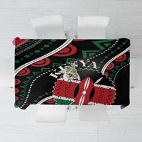 Black tablecloth with large green leaf and red motifs, patterned design