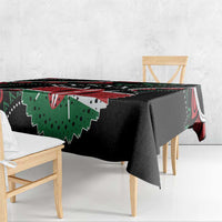 Black tablecloth corner with green and red African pattern, hanging edge visible