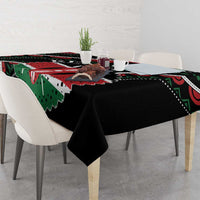 Black tablecloth with green and red patterned design, corners neatly draped