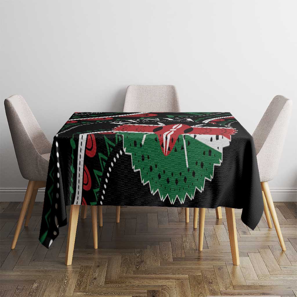 Black tablecloth with bold green and red African pattern, draped over table