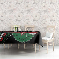 Black tablecloth with green and red African pattern, draped over table