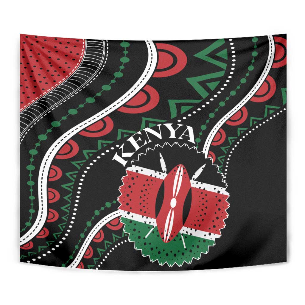 Close-up black African tapestry showing Kenya word, red central emblem, and green dotted trim