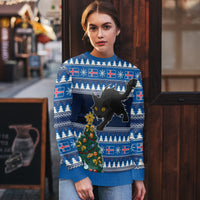 Blue ugly Christmas sweater on model, black cat and decorated Christmas tree front graphic
