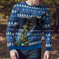 Blue ugly Christmas sweater with black cat and decorated Christmas tree, close-up on torso