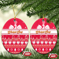 Red oval ceramic Christmas ornaments with white eagle and festive tree pattern, gold hanging loop