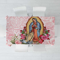 Pink tablecloth with Virgin of Guadalupe portrait, roses, and decorative border patterns.