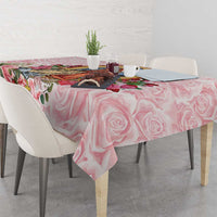 Pink rose tablecloth draped over a dining table, featuring detailed floral prints.