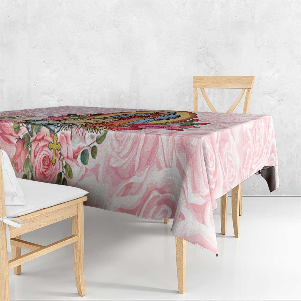 Pink floral tablecloth with rose swirls and leaf accents, draped over a table.